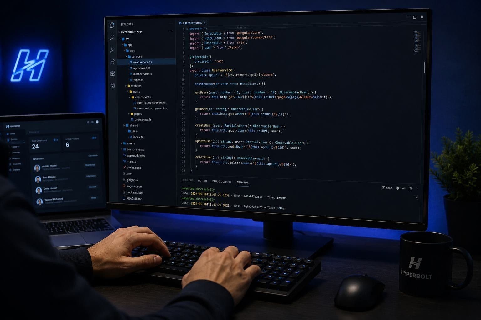 A HyperBolt engineer pair-programming with AI tooling at a dual-screen workstation